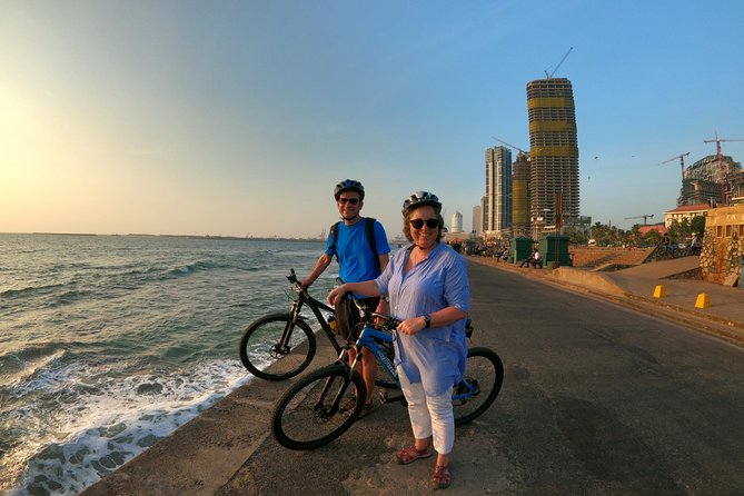Luxury Night Cycle Tour of Colombo - Gangaramaya Temple by Beira Lake: calm waters and a busy business district